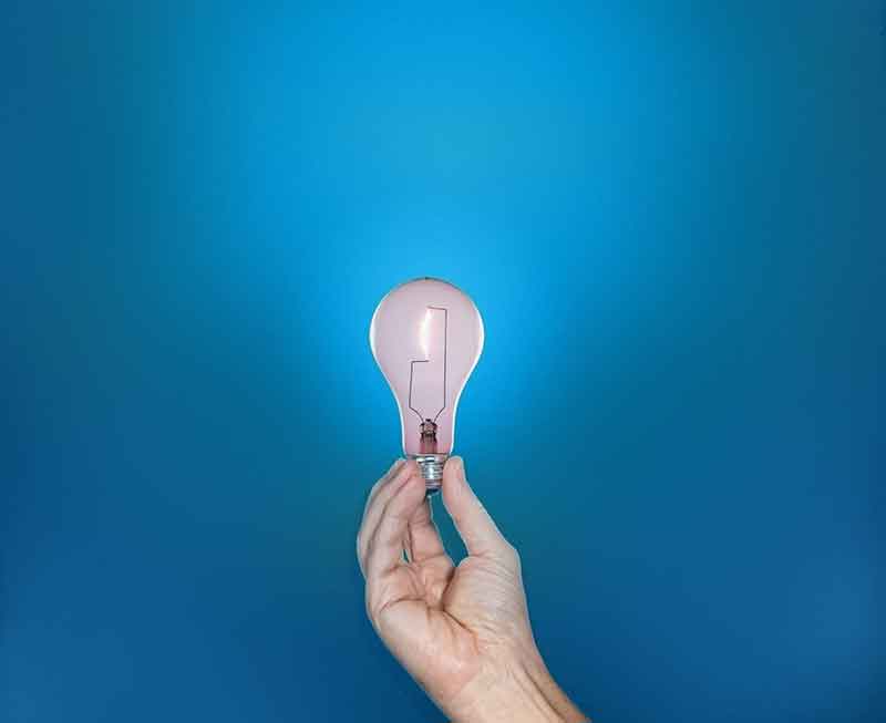 Bright idea lightbulb in hand